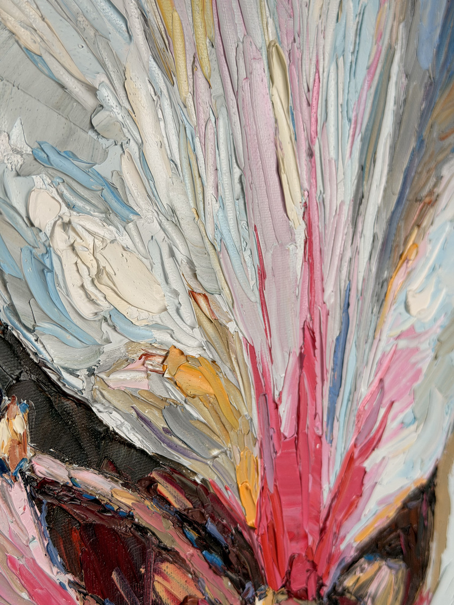 Detail of ivory and blush petals radiating from the blossom's center