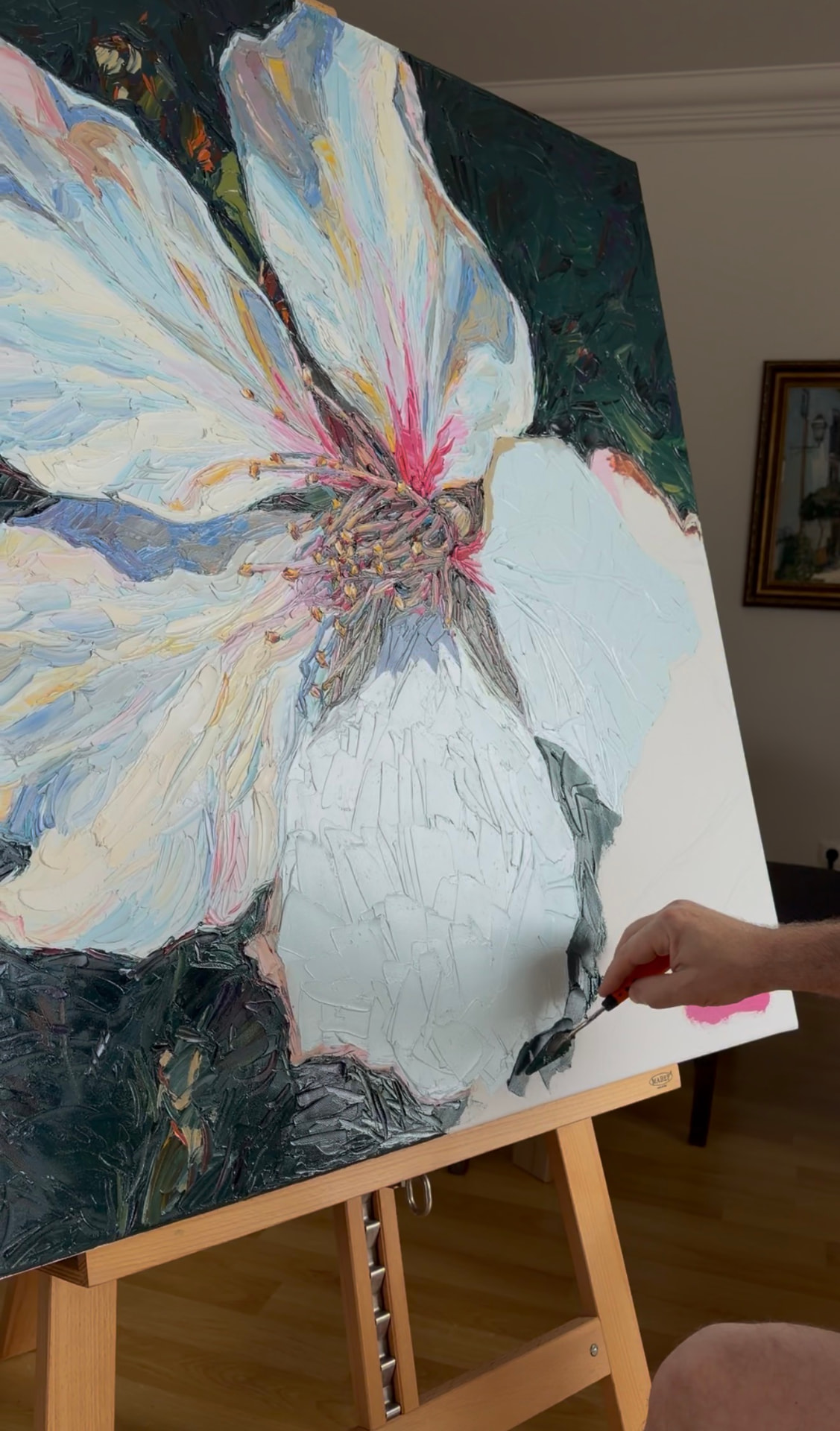 Evgeny Maximov painting the Almond Blossom on the easel in his studio