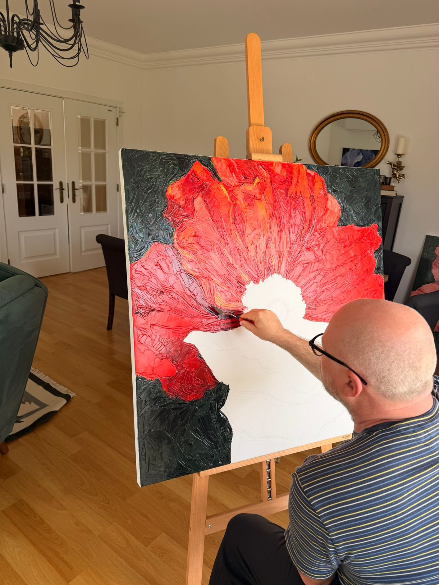 Evgeny Maximov painting the Poppy on the easel in his studio